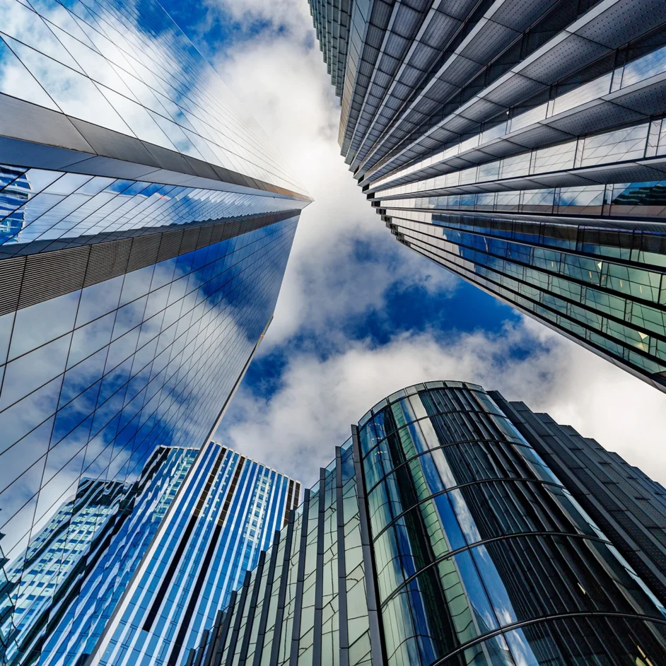 Skyscrapers towering against a bright blue sky, showcasing modern architecture and urban landscape.