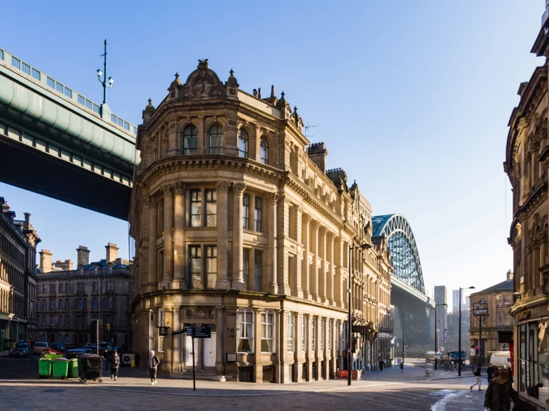 Historic building in Newcastle upon Tyne with Tyne Bridge visible.