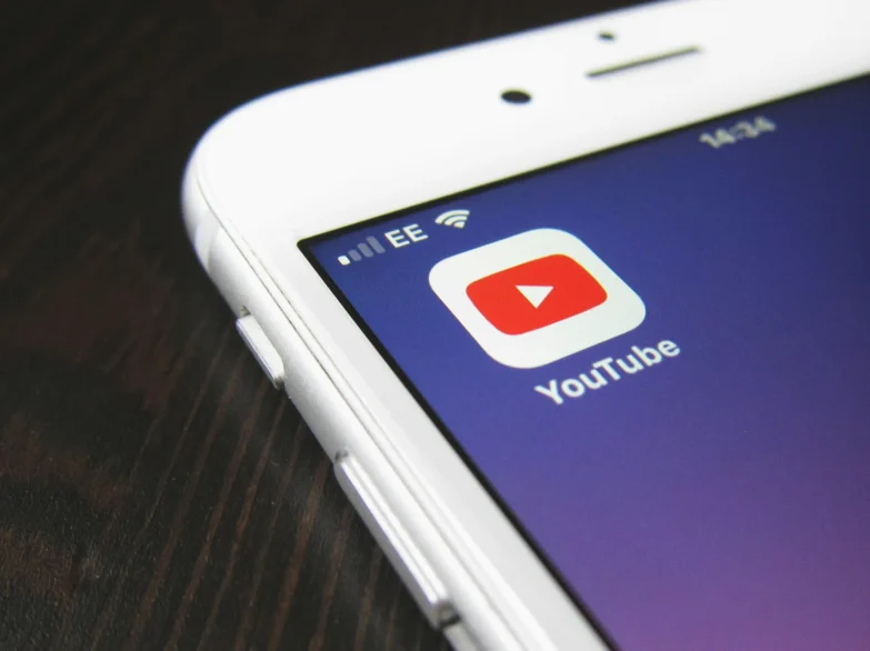 Close up of a mobile phone device displaying the YouTube app.