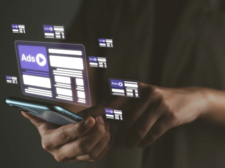 Phone user with superimposed adverts emanating from the screen.