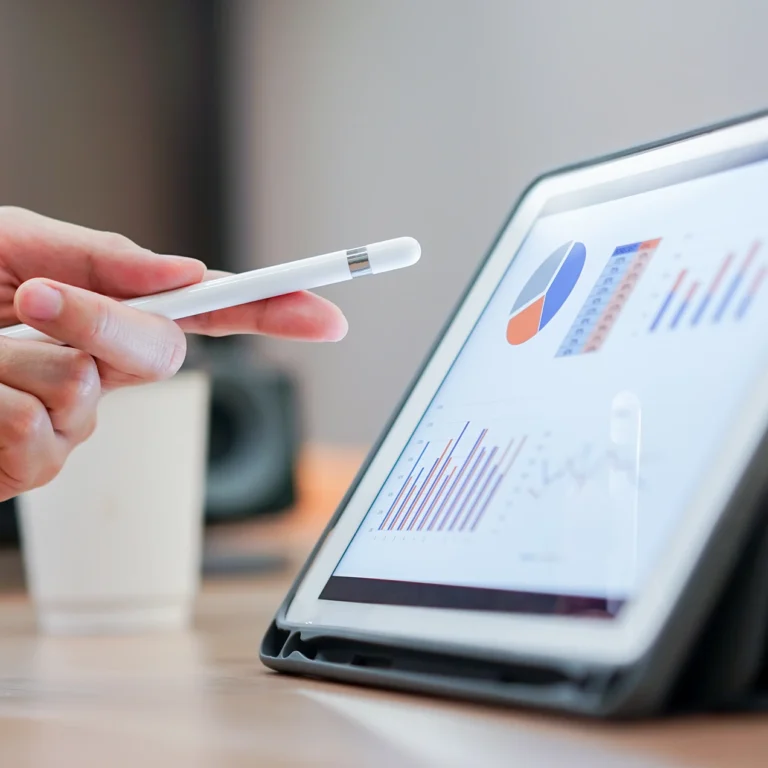 A person holds a pen and points at a tablet screen, engaged in a discussion or presentation.